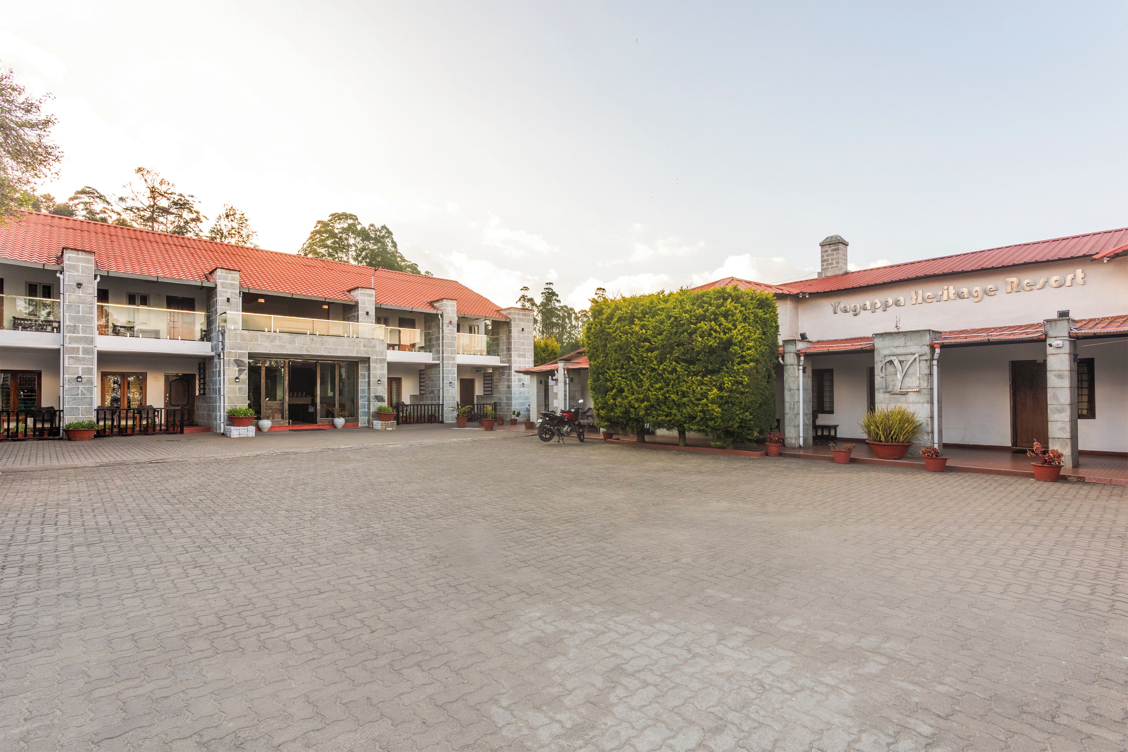 A building with a red roof and a sign that reads 'Yaguppa Heritage Resort.'