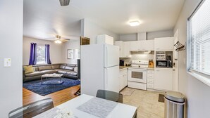 A compact living space with a kitchenette, a dining area, and a seating area with a sofa and coffee table. - Tallahassee Home w/ Yard < 2 Mi to FSU Campus (Tallahassee)