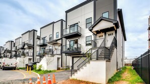 A modern apartment building with multiple balconies and a central staircase. - Modern Elizabeth Apartment ~ 1 Mi to Train Station (Elizabeth)