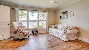 A room with a large window, a chair, a sofa, and a small table. - 'sunset Paradise' on Weiss Lake w/ Private Dock! (Centre)