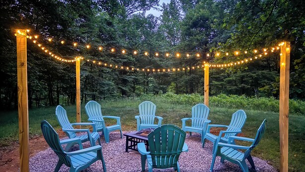 A gazebo with string lights, surrounded by Adirondack chairs on a gravel surface. - Serene Roseland Retreat Near Wintergreen Resort! (Roseland)