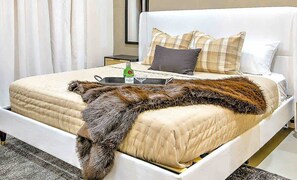A bed with a fur throw, a bottle of water, and a glass on a tray. - 14 Beds Walk 2 Broadway Hot Tub Pool Sauna Firepit (Nashville)