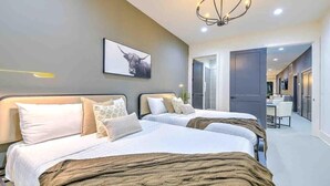A hotel room with two beds, a chandelier, a bull painting, and a view of the hallway. - New-14 Beds! Walk to broadway|Private Hot Tub/Pool (Nashville)