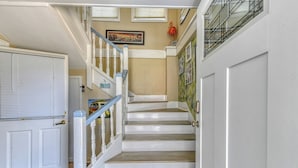 A staircase with white railings and wooden steps leading to a landing. - Carolina Palms - 5 Bedroom Second Row Beach House (Garden City Beach)