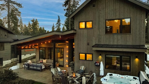 A modern two-story house with a covered patio area featuring outdoor seating and a hot tub. - 5 King Beds on Golf Course with a VIEW 0.6 mile walk to Winery! (Cle Elum)