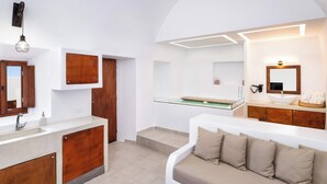 A modern bathroom with a large mirror, a sink, and a vanity. - Santorini Luxury Suite w/ Rooftop HotTub & SeaView (Akrotiri, Santorini)