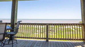 A wooden deck with a view of the ocean. - Beautiful Beachfront Home with Beach Access. (Sargent)