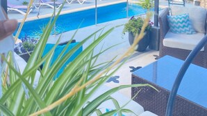 A poolside area with a clear view of the pool, lounge chairs, and a covered seating area with cushions. - Villa Marina, Relax, Piscina Privada, Barbacoa, Wifi (Son Vitamina)