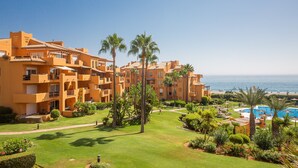 Un complexe hôtelier comprenant des bâtiments à plusieurs étages, une piscine et une vue sur la mer.