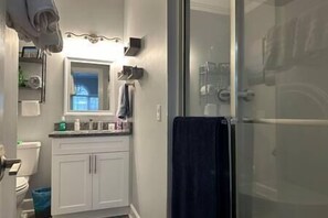 Shower, hair dryer, towels, toilet paper