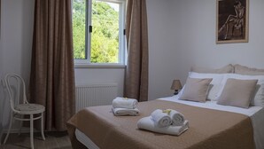 A bedroom with a bed, a chair, a window, and a painting. - Villa Oliva Beautiful Magnificent View, Pool, Newly Built, Close to the Beach (Zaton)