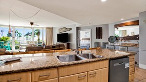 Una cocina moderna con encimeras de granito, electrodomésticos de acero inoxidable y una isla grande.