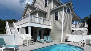 A two-story house with a swimming pool, a covered deck, and a balcony. - 2nd Row, Private Pool and Jacuzzi! (Kure Beach)