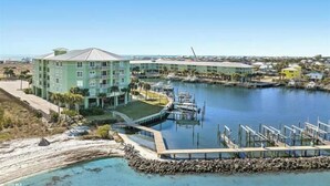 A coastal hotel with multiple buildings, a marina, and a dock area. - Bayfront Bliss: Top-Floor Condo with Stunning Views (Gulf Shores)