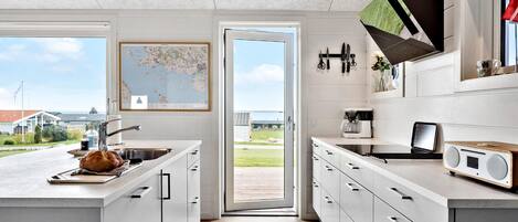 Fridge, stovetop, dishwasher, coffee/tea maker