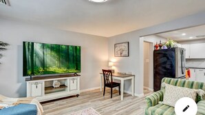 A living room with a flat-screen TV, a dining table with chairs, a sofa, and a kitchen area with a refrigerator. - conveniently located home is perfect for families and friends , near Hershey ! (Palmyra)