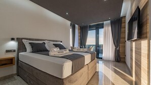 A modern hotel room with a large bed, a flat-screen TV, and a balcony with curtains. - Beautiful home in Privlaka (Privlaka)