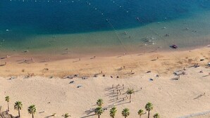 A beach with clear blue water, sandy shore, and palm trees. - Home2Book Pleasant & Design Apt Santa Cruz Center (Santa Cruz de Tenerife)
