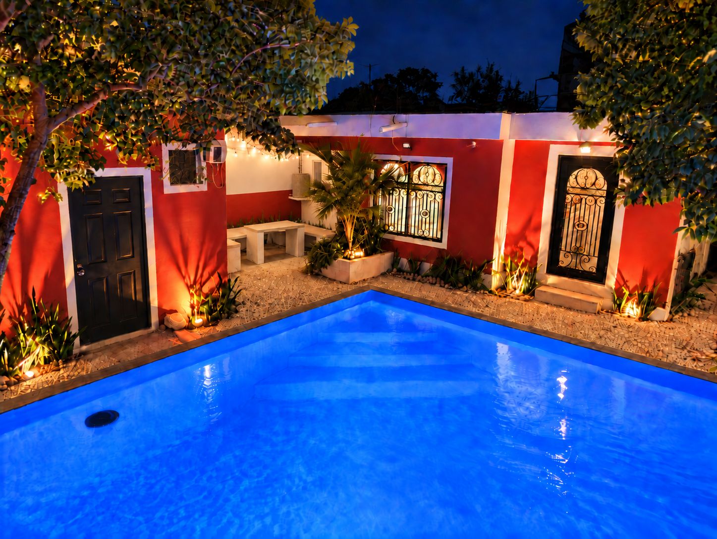 A swimming pool with a red and white building in the background.