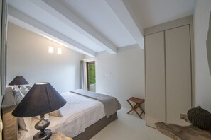A bedroom with a bed, bedside table, lamp, and a view of the outdoors. - MyExclusiveItaly - Villa Chianti with pool near the vineyard (Greve in Chianti)