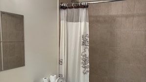 A bathroom with a toilet, sink, and bathtub. - Bethel Hotel Elk Point (Elk Point)