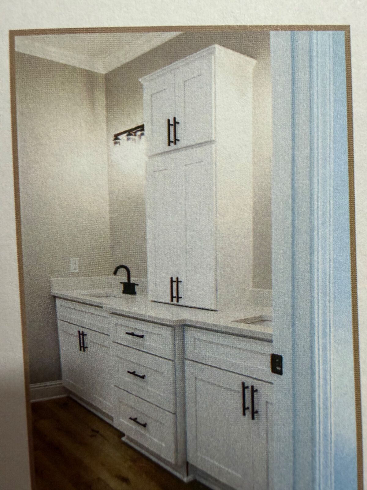A bathroom with white cabinetry, a sink, and a mirror.