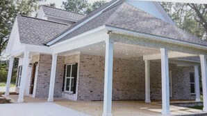 A two-story house with a brick exterior, a covered porch, and a front door. - Heritage Cove  Hide Away 
 charming 3 bed
New Albany only 35 min from Oxford. (New Albany)