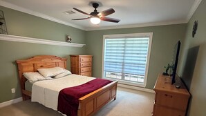 A bedroom with a bed, dresser, ceiling fan, and a window with blinds. - Heritage Cove  Hide Away 
 charming 3 bed
New Albany only 35 min from Oxford. (New Albany)