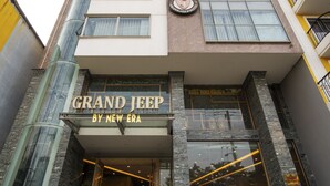A hotel entrance with a sign reading "Grand Jeep by New Era." -  Ocean Hotel (Da Nang)