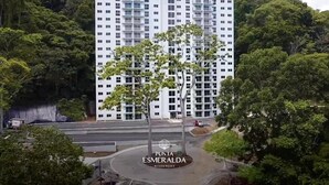 A multi-story residential building with a modern design, surrounded by lush greenery. - Great Apartment Punta Esmeralda (Puntarenas Province)