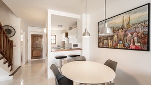 A modern kitchen with white cabinets, a microwave, and a sink. - WELCS CASA ADOSADA 215 EMP con piscina comunitaria (Rosas / Roses)