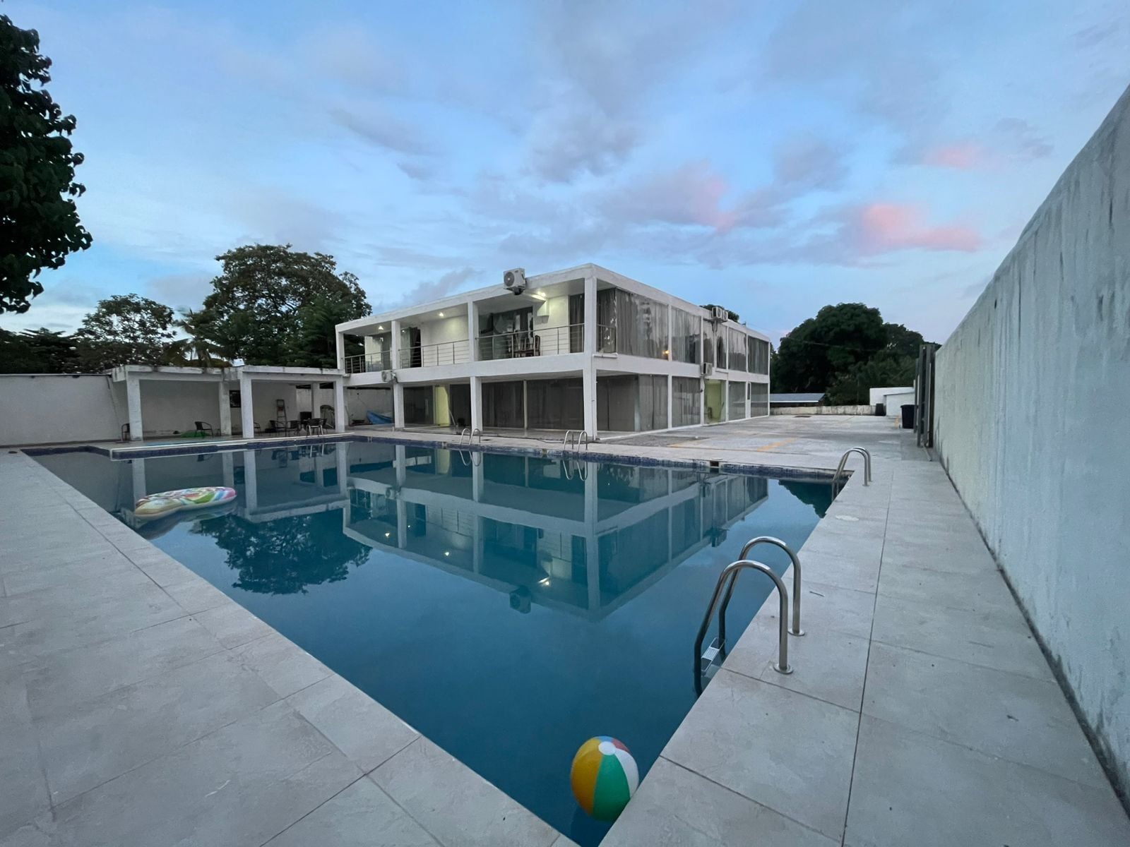A swimming pool with a modern building in the background.
