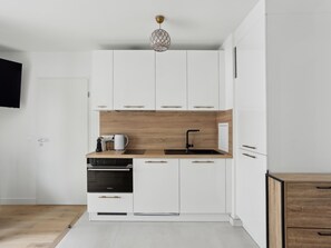 Fridge, microwave, coffee/tea maker, cookware/dishes/utensils