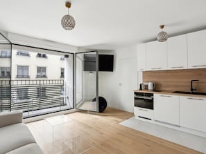 Enjoy a comfortable stay in this stylish apartment with a sofa, clear glass partition, and city views.