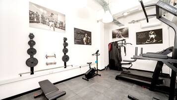 A gym with weightlifting equipment, treadmills, and exercise bikes.