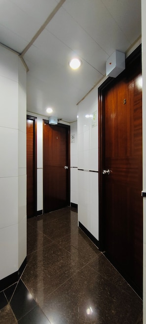 Stylish hallway with three doors leading to a suite.