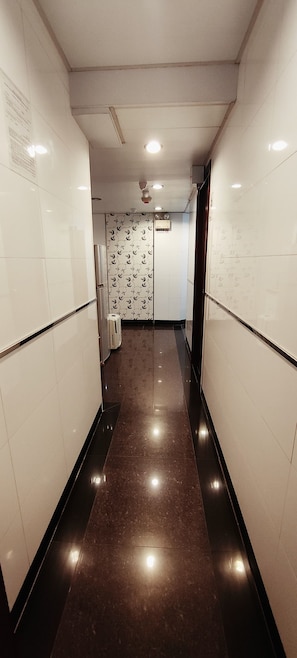 Corridors feature patterned wallpaper and polished floors.