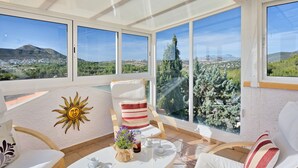 A sunlit room with a large window overlooking a mountainous landscape. - Casa Los Caracoles by Interhome (Jávea)