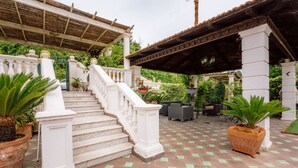 A covered outdoor area with a staircase, potted plants, and outdoor furniture. - Villa Elide with private pool (Massa Lubrense)