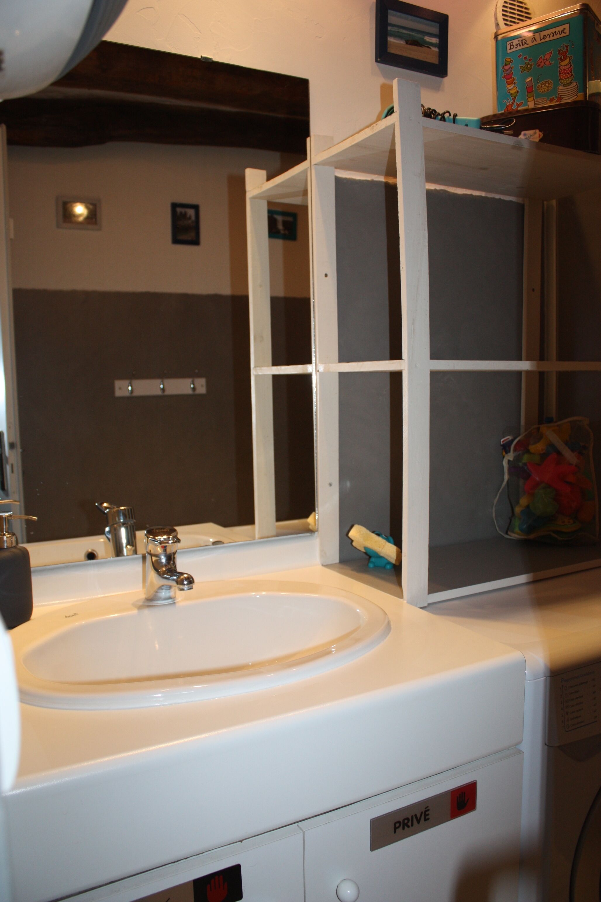 A bathroom with a white sink, a mirror, and a cabinet.