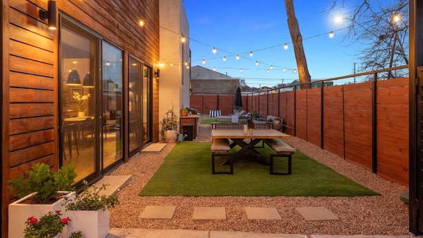 A backyard with a wooden deck, a barbecue area, and a patio with a table and chairs. - NEW Luxe DT Austin Oasis | Pool | Casita (Austin)