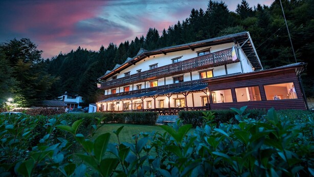 A two-story building with balconies, surrounded by greenery and trees. - RESORT 7 CRAI (Zarnesti)