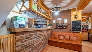 A cozy bar area with a brick wall, wooden counter, and a leather couch. - RESORT 7 CRAI (Zarnesti)