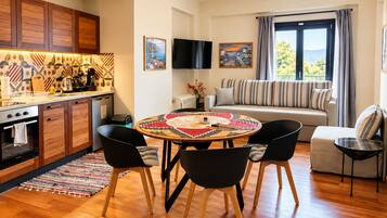 A modern living space with a kitchen, dining area, and seating area.