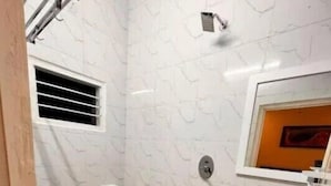A bathroom with a toilet, bidet, sink, and a showerhead. - Izi Airport Stay (Chennai)