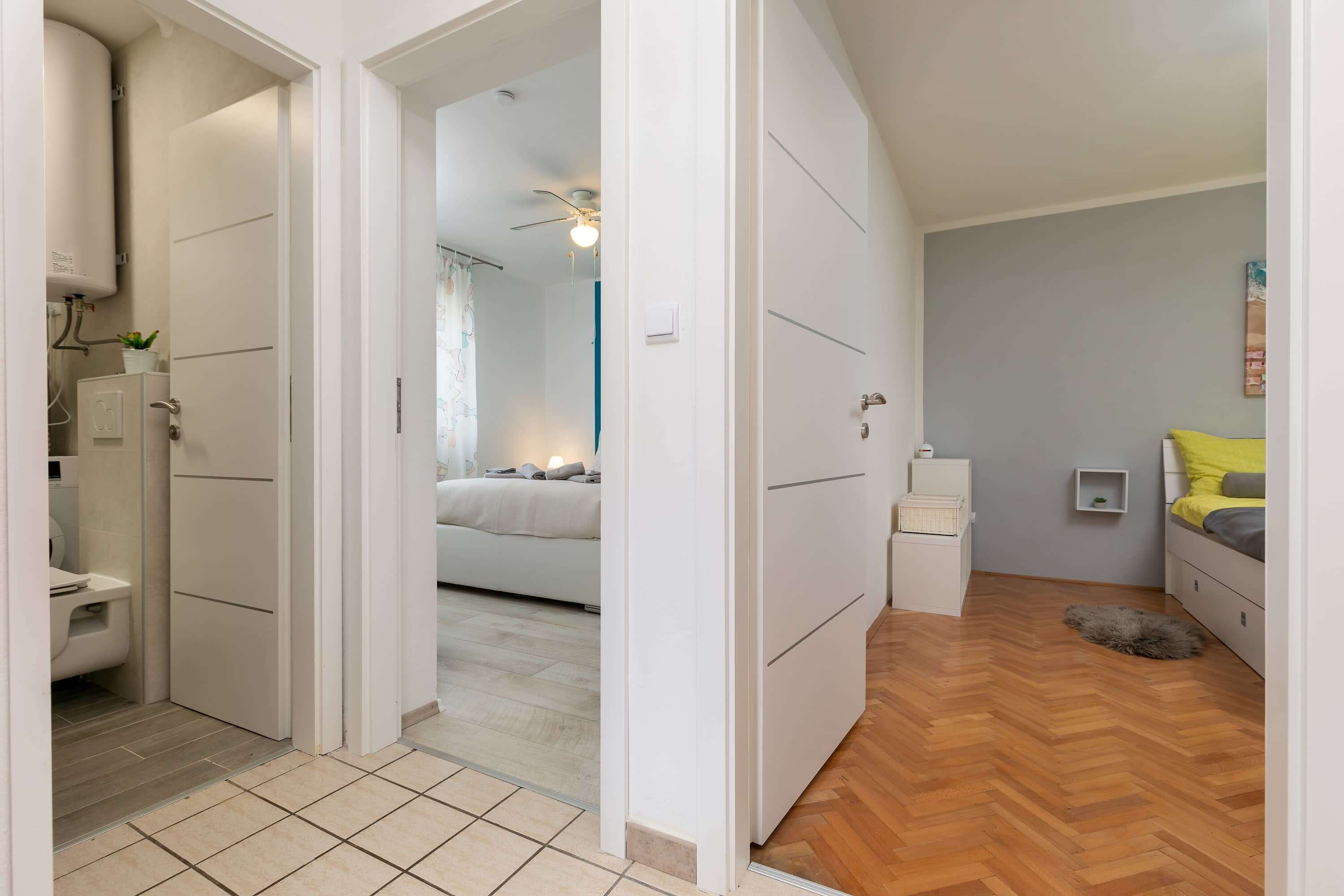 A bedroom with a bed, bedside table, and a small rug.