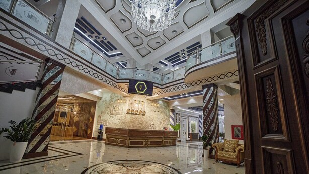 A grand lobby with a marble floor, a chandelier, and a reception desk. - COMFORT HOTEL SAMARKAND (Samarkand)