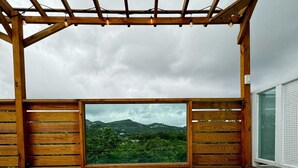A hot tub with a view of a mountainous landscape.