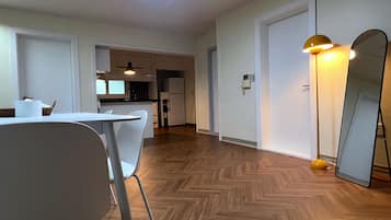Family Studio Suite | Living area | 23-inch flat-screen TV with cable channels, heated floors