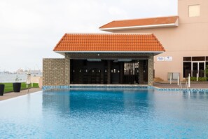 Relax by the pool at Pulse, surrounded by a tranquil body of water.